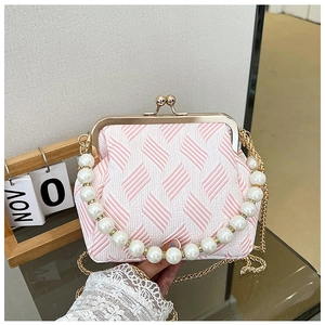 Detailed view of pink geometric fabric texture with luxury pearl handle and gold clasp