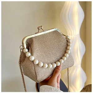 Detail of champagne gold sequin evening bag with pearl handle and metal clasp