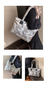 Detail view of large silver quilted puffer tote bag with metallic finish and padded texture