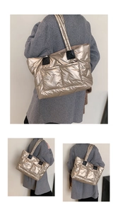 Detail of champagne gold quilted tote bag with outer pockets and black leather handles