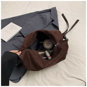 Spacious interior of dark brown suede tote bag showing large capacity for cosmetics