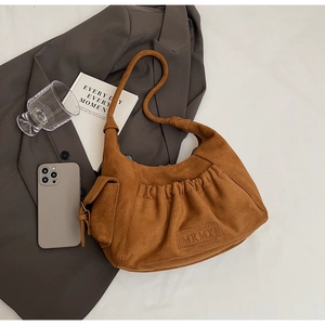 Detail view of caramel brown suede tote bag with stylish pleats and MKMX side pocket