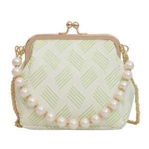 Fashionable white striped frame bag with elegant pearl handle and gold chain strap