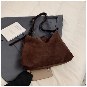 Detail view of large dark brown suede hobo bag with adjustable leather shoulder strap