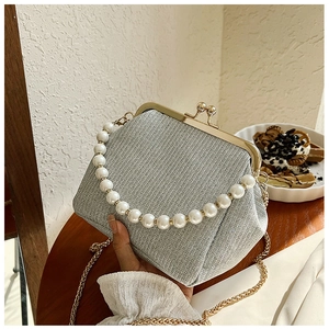 Detail of silver sequin evening bag with pearl handle and vintage metal clasp closure