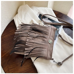Top view of a bohemian dark brown fringe crossbody bag with metal ring and suede texture
