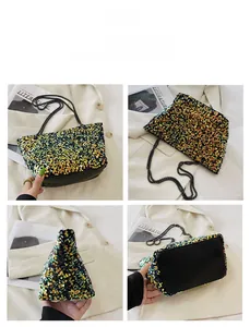 Detail view of sequined crossbody bag with green gold sequins and chain strap