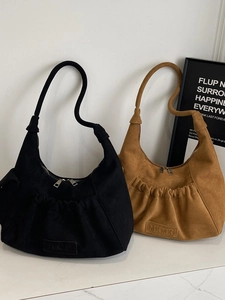 Minimalist hobo style tote bags in black and camel colors with textured matte finish
