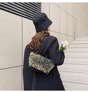 Detail of elegant sequined crossbody bag with a metal chain strap for stylish daily wear