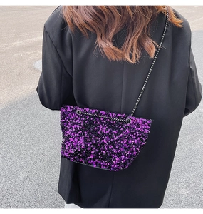Detailed shot of a purple and black sequined crossbody bag with a slim metal chain strap