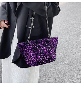 Detailed close-up of violet sequin tote bag with metallic chain strap and high-shine finish