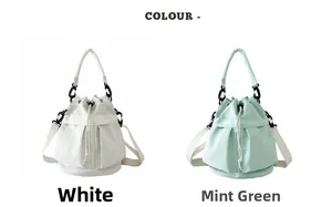 Detail view of white and mint green nylon bucket bags with drawstring and black carabiners