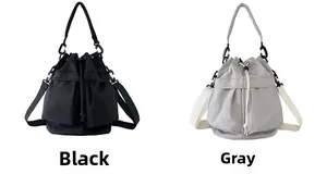 Detail view of large capacity nylon bucket bags in black and grey colors with drawstrings
