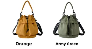 Detail view of nylon drawstring bucket bags in orange and army green with utility pockets