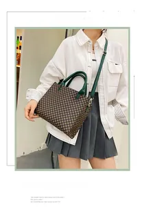 Retro tote bag with geometric patterns worn by a model in a stylish white shirt