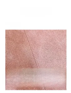 Detailed macro view of the precise double-stitching on a pink suede tote bag surface