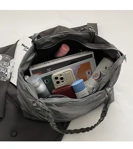 Interior view showing large storage capacity of a grey quilted puffer tote bag