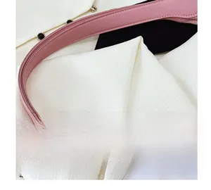 Detail view of pink leather strap with precise oil-edge finish and smooth texture
