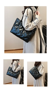 Three-way view of a black quilted puffer tote bag with V-shaped patterns and woven handles