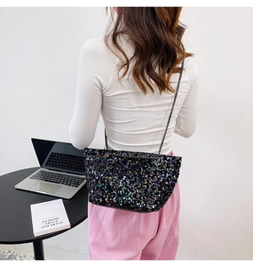 Detail shot of the iridescent sequins and dark nickel chain strap on the stylish bucket bag
