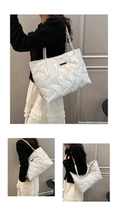 Detail of white quilted puffer tote bag with woven handles and geometric stitching