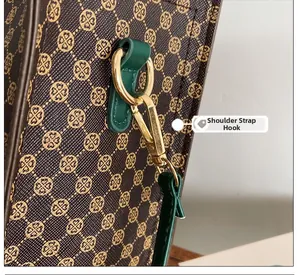 Close-up of golden shoulder strap hook and D-ring on a retro floral print tote bag