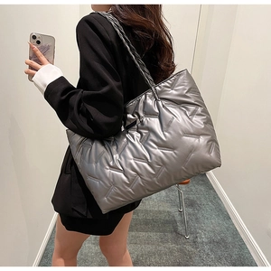 Silver quilted tote bag with metallic finish showing large capacity for daily commute