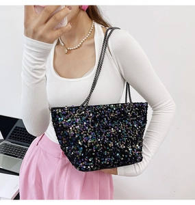 Detailed view of iridescent black sequin tote bag with sleek metallic chain strap