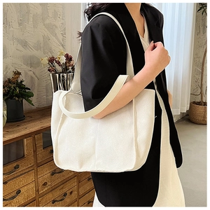 Minimalist white nylon tote bag shown on a model for a stylish lifestyle look