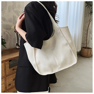 Close-up of minimalist white large capacity tote bag with vertical stitching detail