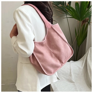 Detail of light pink large tote bag with vertical stitching and smooth handles