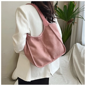 Macro detail of plush rose pink tote bag with soft texture and leather strap accents