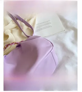 Close-up of light purple leather texture and pleated details on the cloud bag