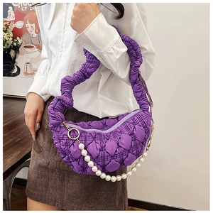 Detail of purple pleated quilted shoulder bag with white pearl chain and gold zipper