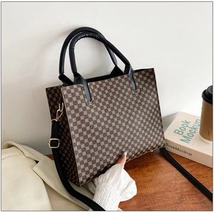 Detailed view of a retro tote bag with geometric patterns and gold metal hardware