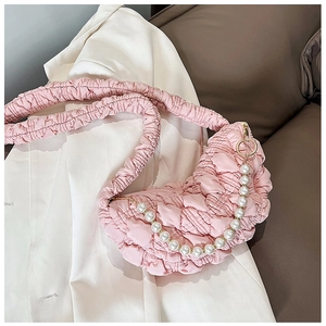 Detailed view of pink bubble texture bag with faux pearl chain and scrunchie strap