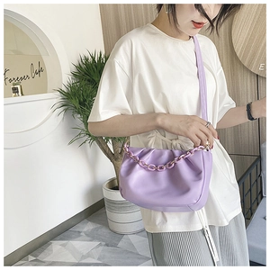 Detail of light purple pleated cloud bag with stylish thick chain and soft leather texture