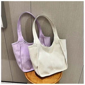 Close-up of soft purple and beige plush tote bags on a wooden stool for daily commute
