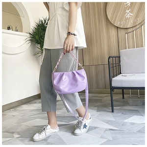 Detail of lavender purple pleated cloud bag showing soft PU texture and chain strap