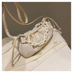 Détail du sac nuage plissé crème avec chaîne en acrylique et anneaux en métal argenté