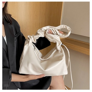 Detail showing the pleated handle and smooth leather texture of the off-white cloud bag