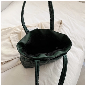 Top view of spacious interior with lining and zip pocket in dark green quilted tote bag