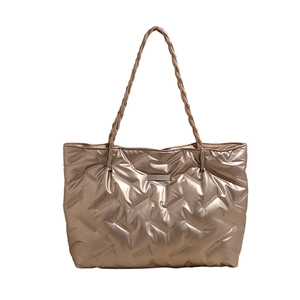 Metallic champagne gold quilted tote bag with large capacity and stylish woven handles