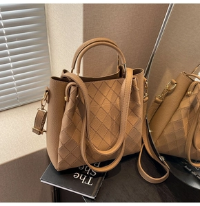 Detail of khaki bucket bag showing quilted diamond pattern and pebble grain texture