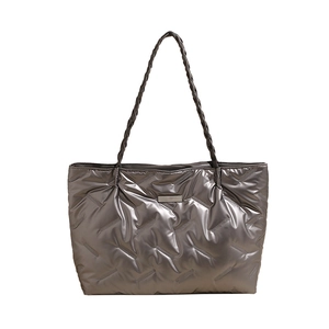 Metallic silver quilted down tote bag with woven shoulder straps and metallic logo