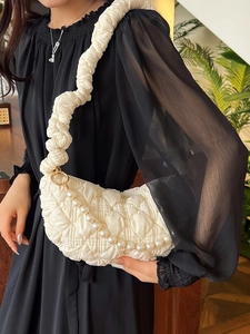 Creamy white quilted puffy shoulder bag with ruched strap and elegant pearl chain accessory