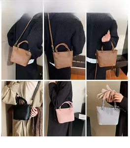 Detailed close-up showing pleated vertical texture and stylish twisted handle on bucket bag