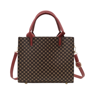 Classic tote bag with vintage geometric prints, red handles, and detachable shoulder strap