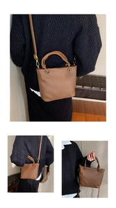 Detail view showing vertical pleated texture and wrapped handle of the brown tote bag