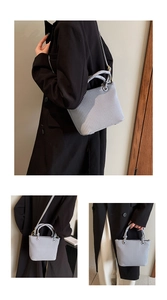 Detail showing the vertical pleats and golden hardware of the stylish bucket bag